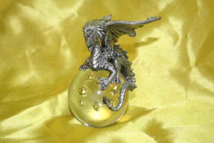 pewter dragon perched on sphere