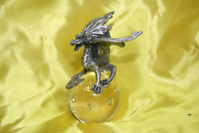 Pewter dragon on top of a sphere